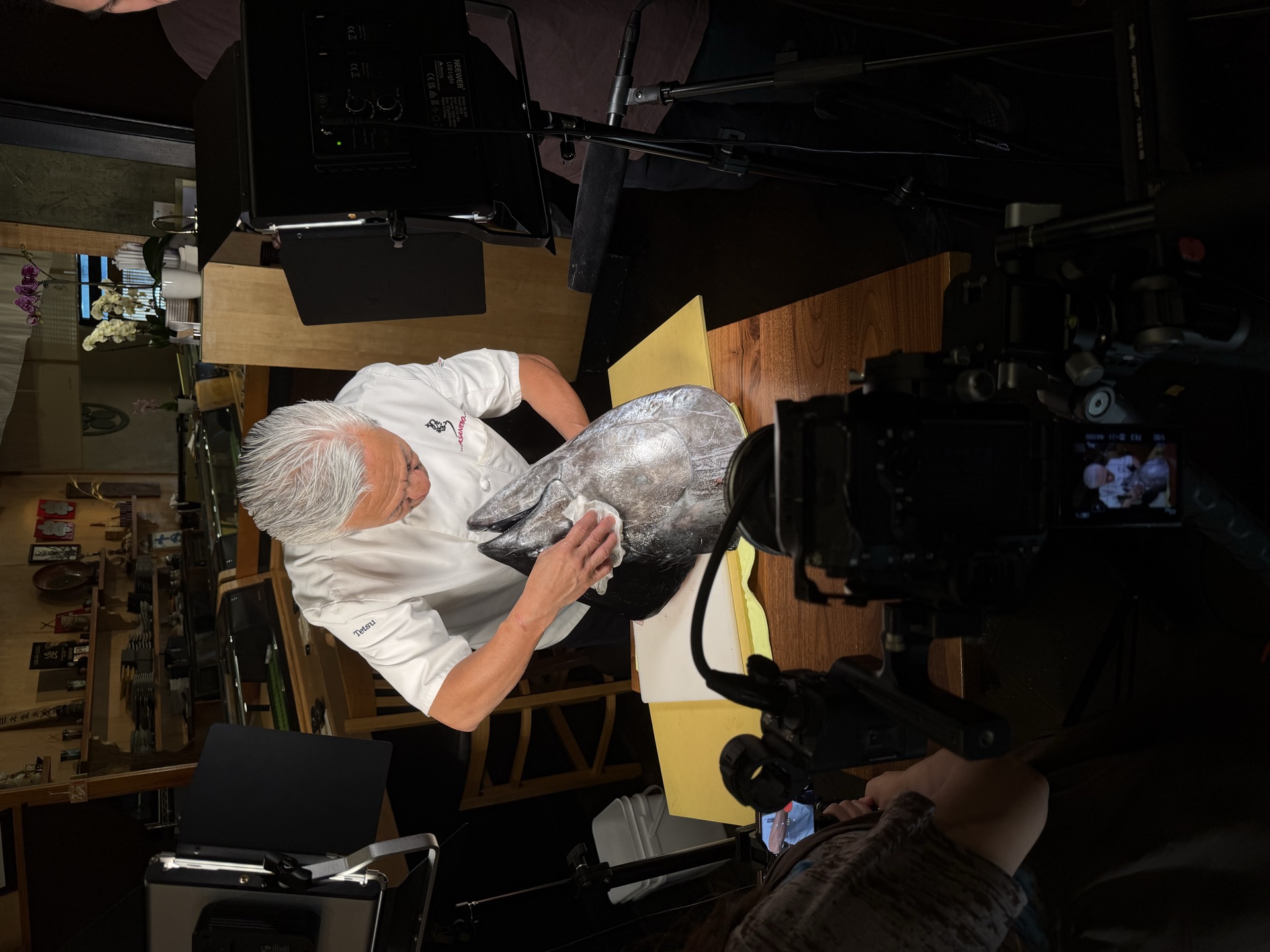 Chef breaking down a whole tuna on camera